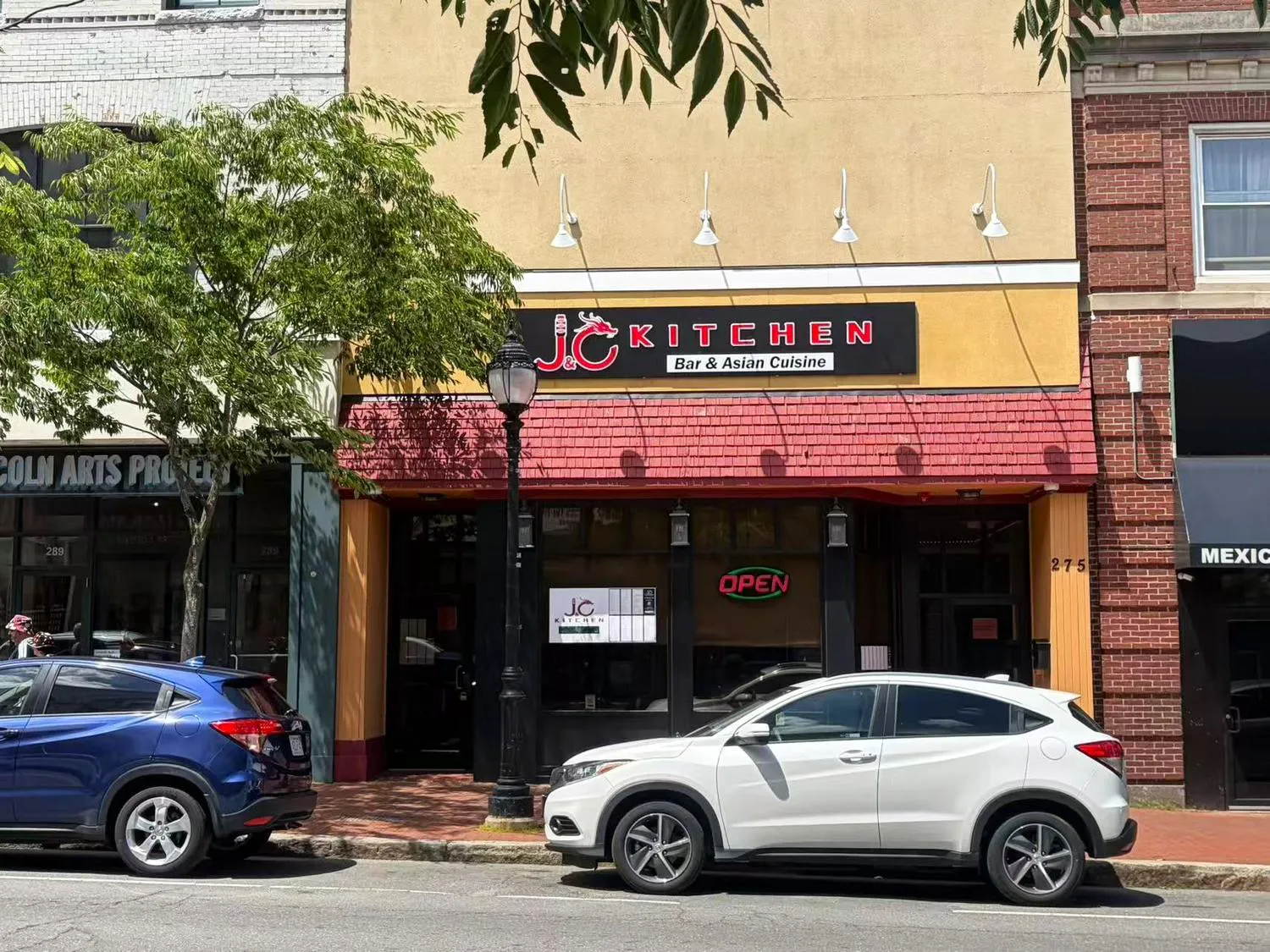 Street view of J & C Kitchen storefront with red awning and branded signage at J & C Kitchen, Chinese Restaurant in Waltham